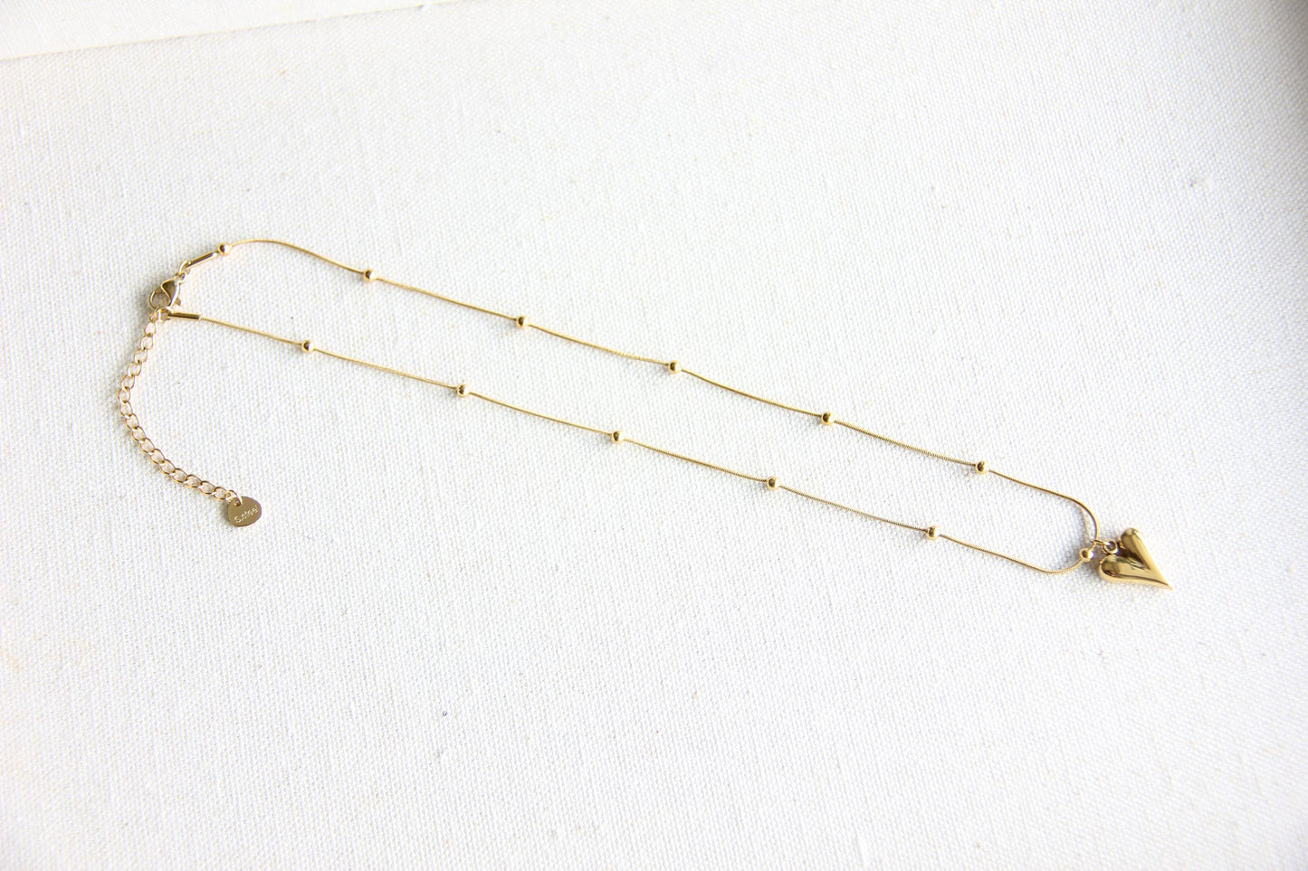 Add timeless elegance to your look with our dainty Beaded Chain Heart Pendant Charm Necklace. A perfect everyday accessory that radiates love and style!