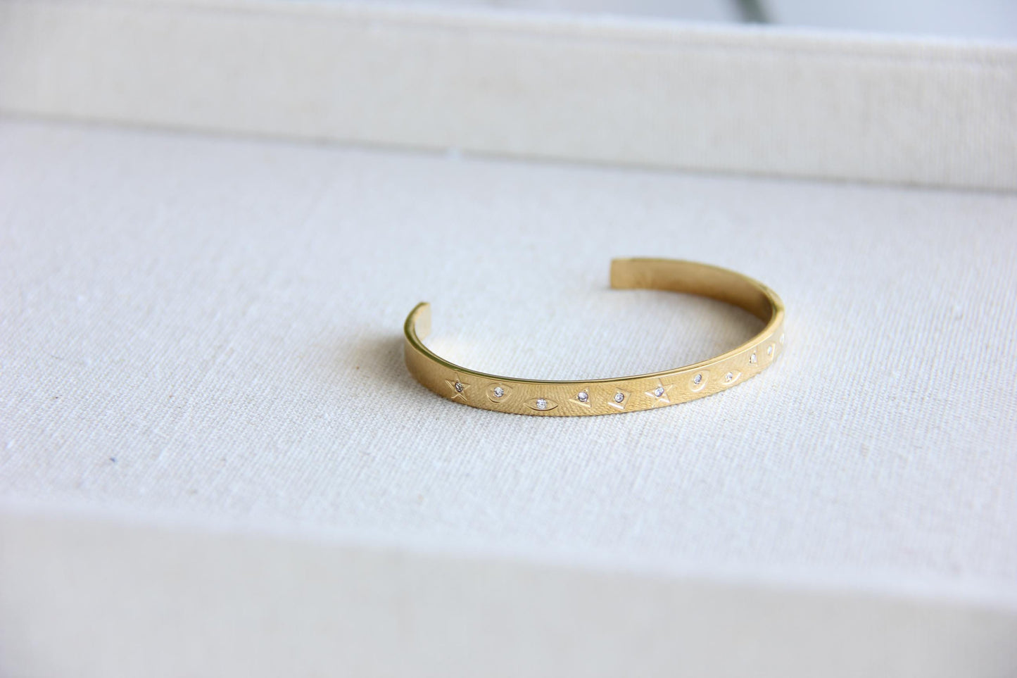 Gold and silver celestial cuff bracelet with star and moon engravings, adorned with sparkling crystals. A stylish cosmic-inspired accessory, perfect for stacking or wearing solo. Great celestial jewelry gift for women