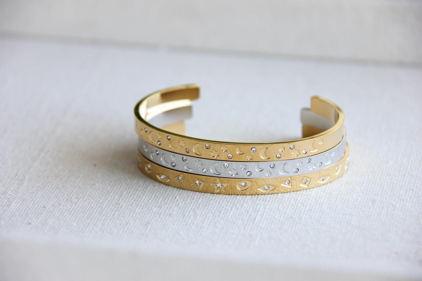 Gold and silver celestial cuff bracelet with star and moon engravings, adorned with sparkling crystals. A stylish cosmic-inspired accessory, perfect for stacking or wearing solo. Great celestial jewelry gift for women