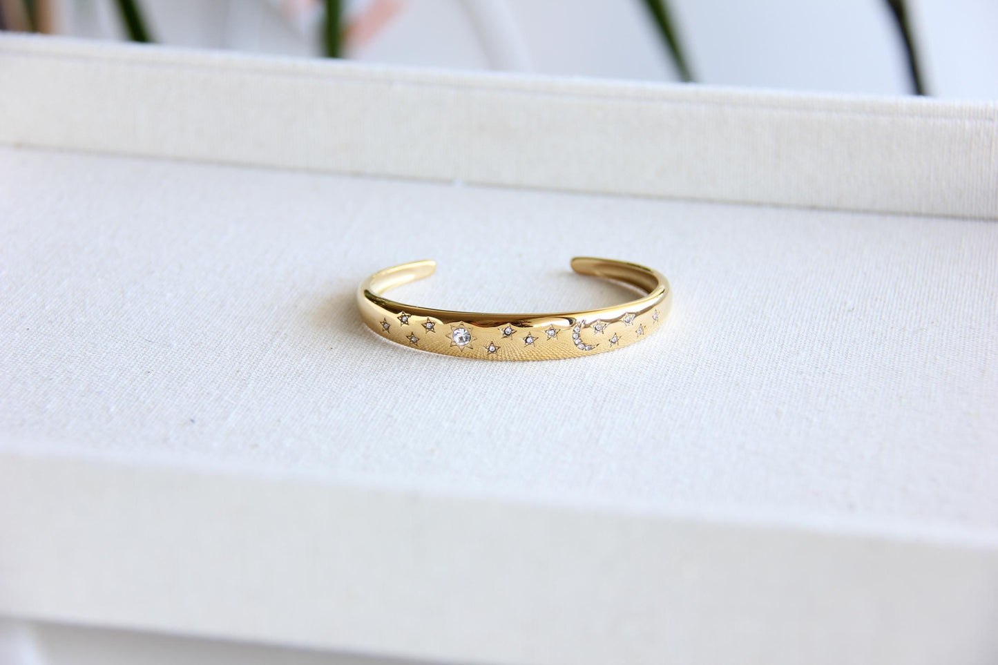 Gold and silver celestial cuff bracelet with star and moon engravings, adorned with sparkling crystals. A stylish celestial-inspired accessory, perfect for stacking or wearing solo. Great celestial jewelry gift for women