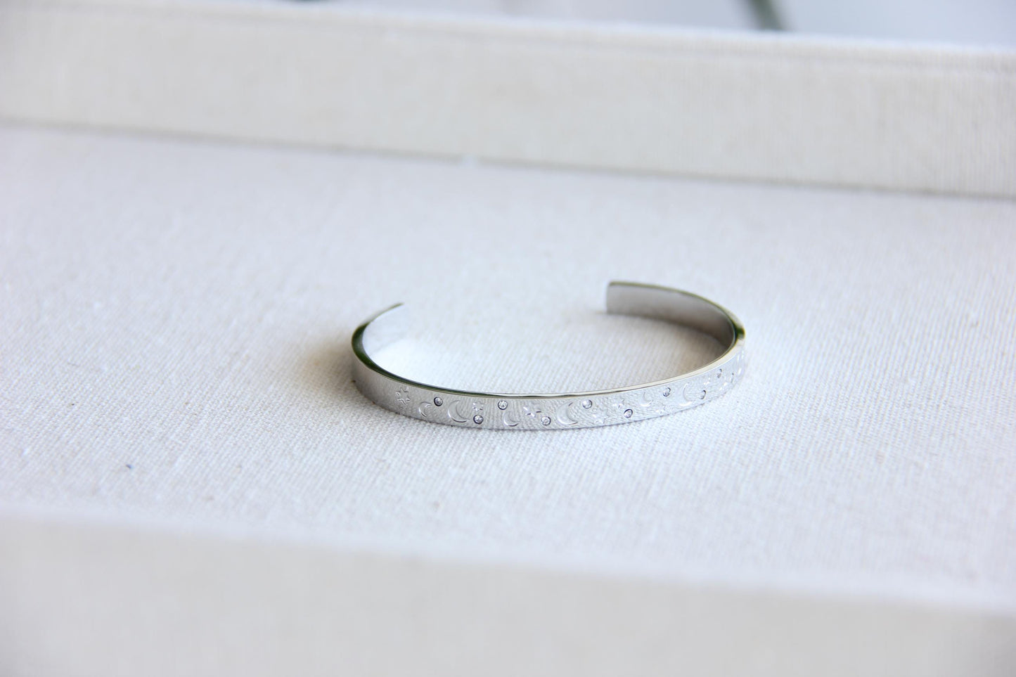 Gold and silver celestial cuff bracelet with star and moon engravings, adorned with sparkling crystals. A stylish cosmic-inspired accessory, perfect for stacking or wearing solo. Great celestial jewelry gift for women