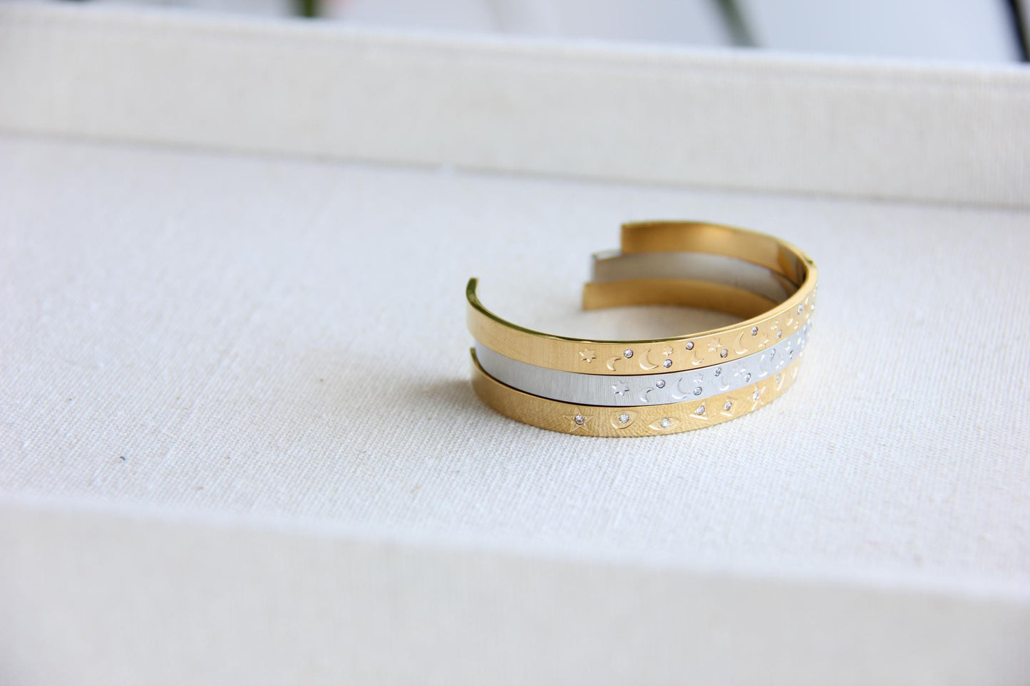 Gold and silver celestial cuff bracelet with star and moon engravings, adorned with sparkling crystals. A stylish cosmic-inspired accessory, perfect for stacking or wearing solo. Great celestial jewelry gift for women