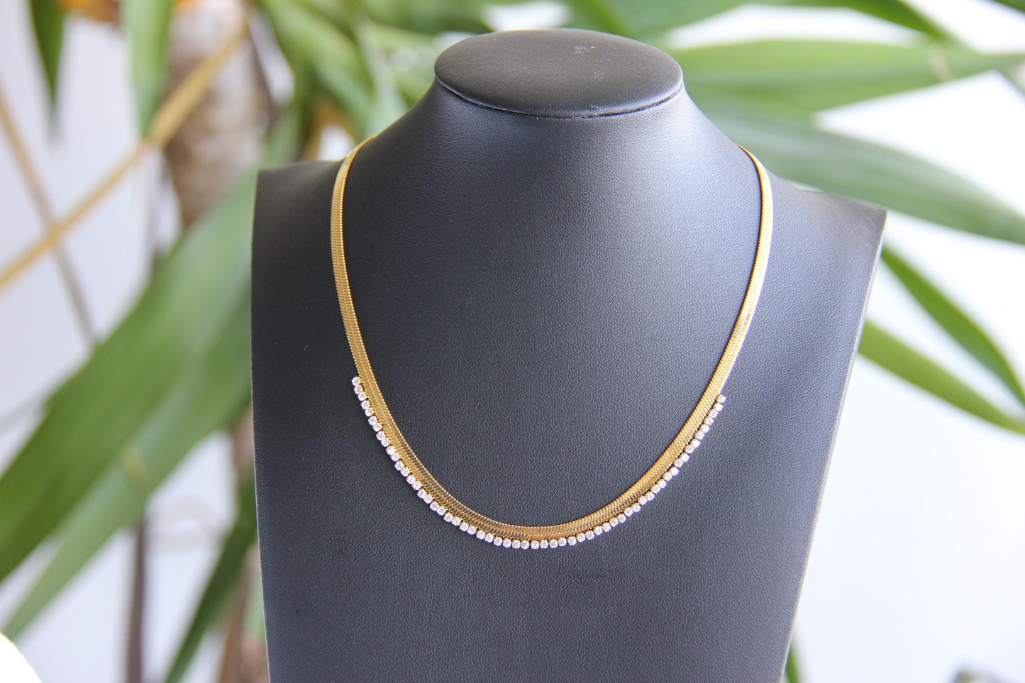 Gold snake necklace with sparkling zirconia stones, featuring a unique and minimalist design. Dainty and trendy serpent chain statement necklace, perfect for layering or wearing solo.