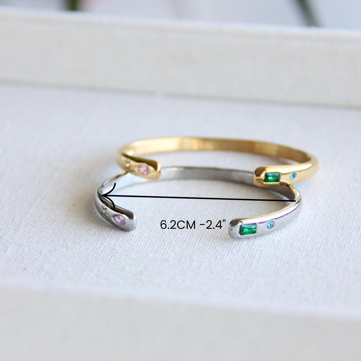 Gold and silver open cuff bracelet with pink gemstone and starburst engraving. Elegant celestial-inspired jewelry, perfect for stacking or wearing alone. Minimalist astrology bracelet, great gift for women who love dainty and cosmic jewelry.