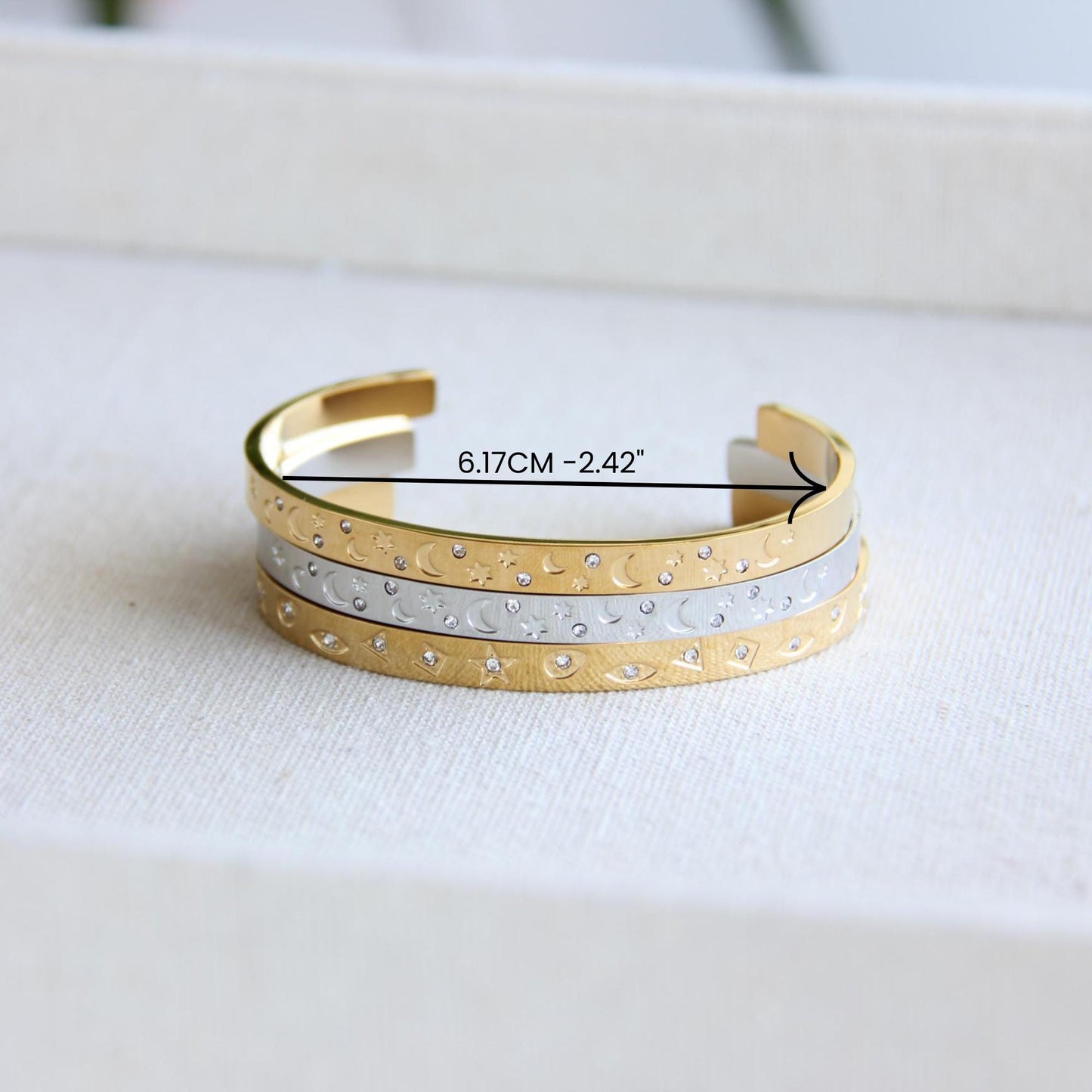 Gold and silver celestial cuff bracelet with star and moon engravings, adorned with sparkling crystals. A stylish cosmic-inspired accessory, perfect for stacking or wearing solo. Great celestial jewelry gift for women