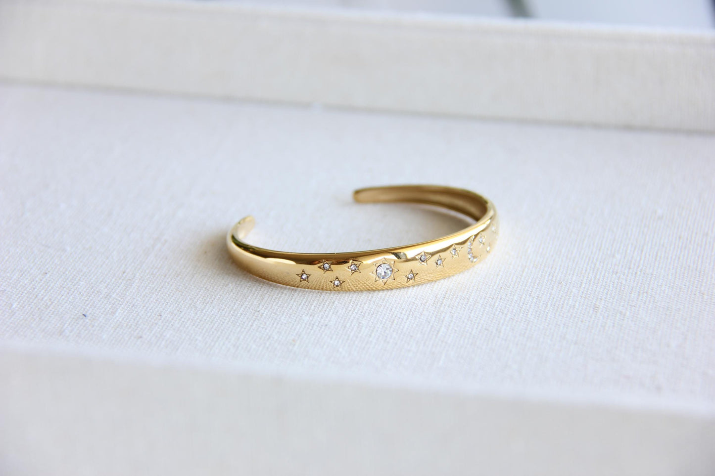 Gold and silver celestial cuff bracelet with star and moon engravings, adorned with sparkling crystals. A stylish celestial-inspired accessory, perfect for stacking or wearing solo. Great celestial jewelry gift for women