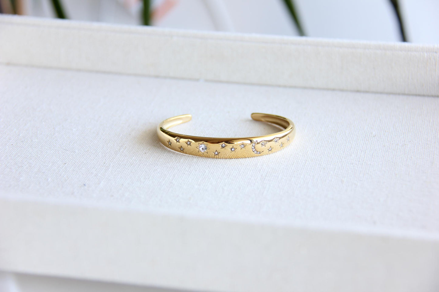 Gold and silver celestial cuff bracelet with star and moon engravings, adorned with sparkling crystals. A stylish celestial-inspired accessory, perfect for stacking or wearing solo. Great celestial jewelry gift for women