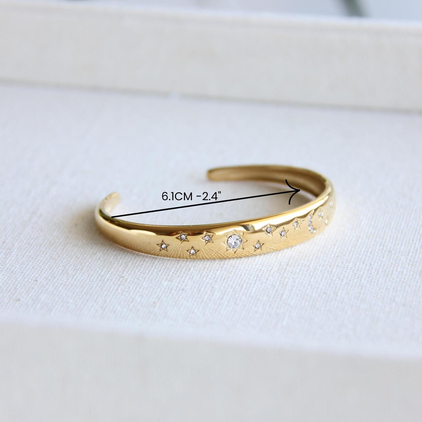 Gold and silver celestial cuff bracelet with star and moon engravings, adorned with sparkling crystals. A stylish celestial-inspired accessory, perfect for stacking or wearing solo. Great celestial jewelry gift for women