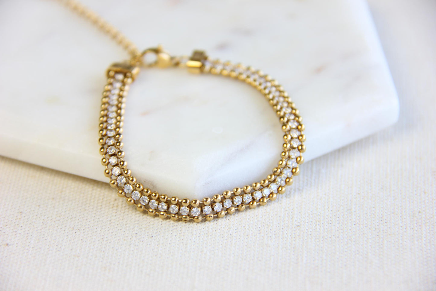 Beautiful zirconia woven gold bracelet with a touch of sparkle. Its delicate design and shimmering stones make it perfect for any outfit. Great for everyday wear, special occasions, or as a lovely gift for her.