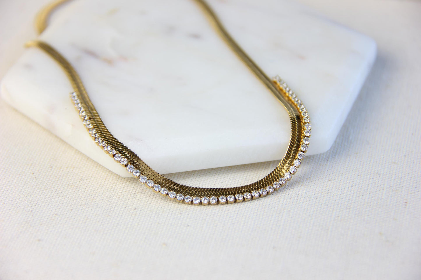 Gold snake necklace with sparkling zirconia stones, featuring a unique and minimalist design. Dainty and trendy serpent chain statement necklace, perfect for layering or wearing solo.
