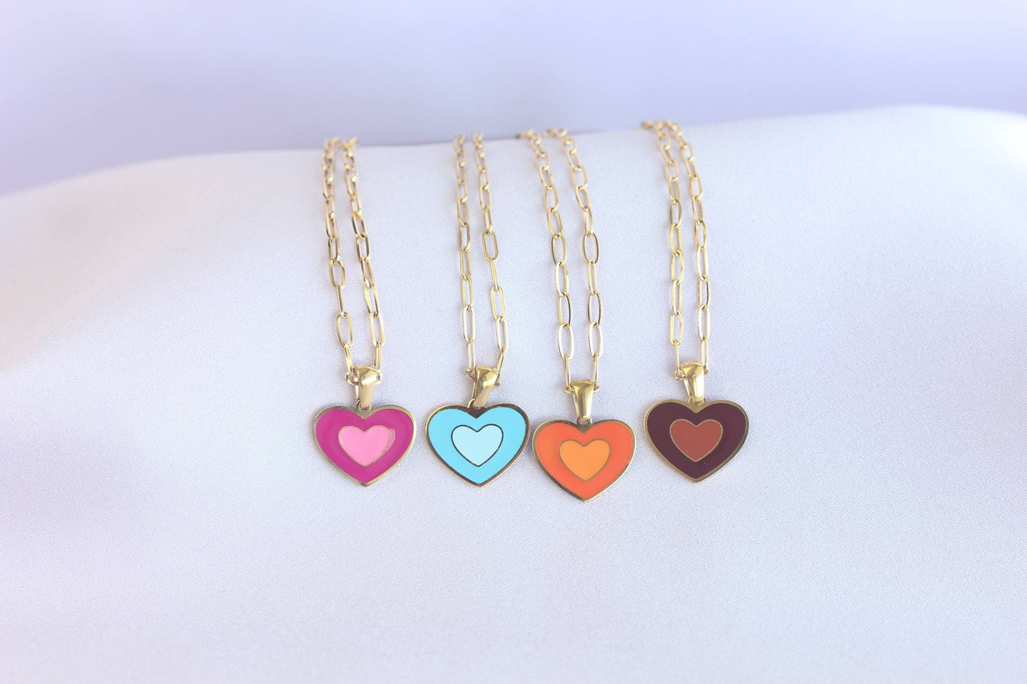 Brighten up your outfit with our Colorful Heart Pendant Chain Necklaces! Whether you&#39;re dressing up for a special event or adding a pop of color to your everyday look, this necklace offers dainty and colorful style. Perfect gift for her.
