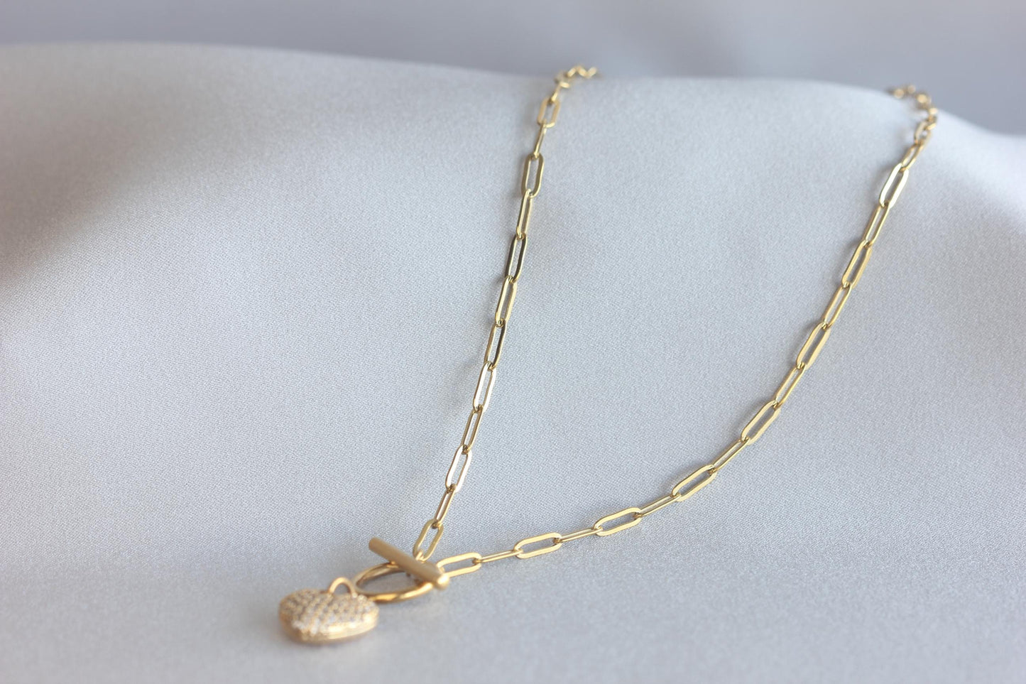 Link Chain Drop Heart Necklace reflects the beautiful harmony between one of the most popular chain type Link Chain and Cubic zirconia beaded shiny heart charm. Perfect gift for your her or for yourself!