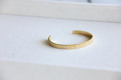 Gold and silver celestial cuff bracelet with star and moon engravings, adorned with sparkling crystals. A stylish cosmic-inspired accessory, perfect for stacking or wearing solo. Great celestial jewelry gift for women