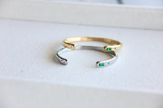 Gold and silver open cuff bracelet with pink gemstone and starburst engraving. Elegant celestial-inspired jewelry, perfect for stacking or wearing alone. Minimalist astrology bracelet, great gift for women who love dainty and cosmic jewelry.