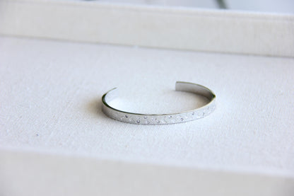 Gold and silver celestial cuff bracelet with star and moon engravings, adorned with sparkling crystals. A stylish cosmic-inspired accessory, perfect for stacking or wearing solo. Great celestial jewelry gift for women