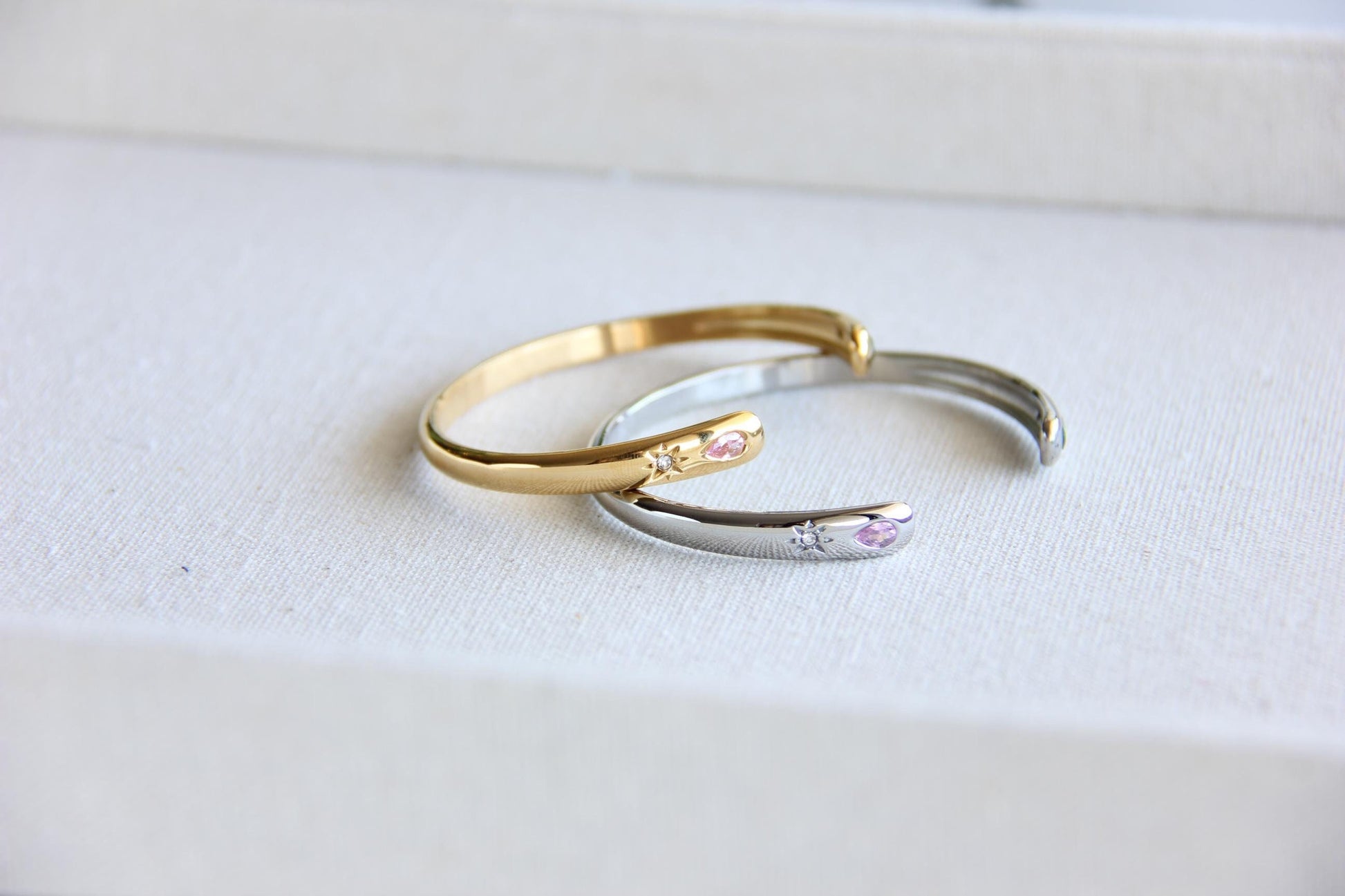 Gold and silver open cuff bracelet with pink gemstone and starburst engraving. Elegant celestial-inspired jewelry, perfect for stacking or wearing alone. Minimalist astrology bracelet, great gift for women who love dainty and cosmic jewelry.