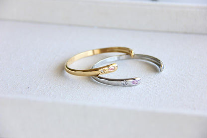 Gold and silver open cuff bracelet with pink gemstone and starburst engraving. Elegant celestial-inspired jewelry, perfect for stacking or wearing alone. Minimalist astrology bracelet, great gift for women who love dainty and cosmic jewelry.