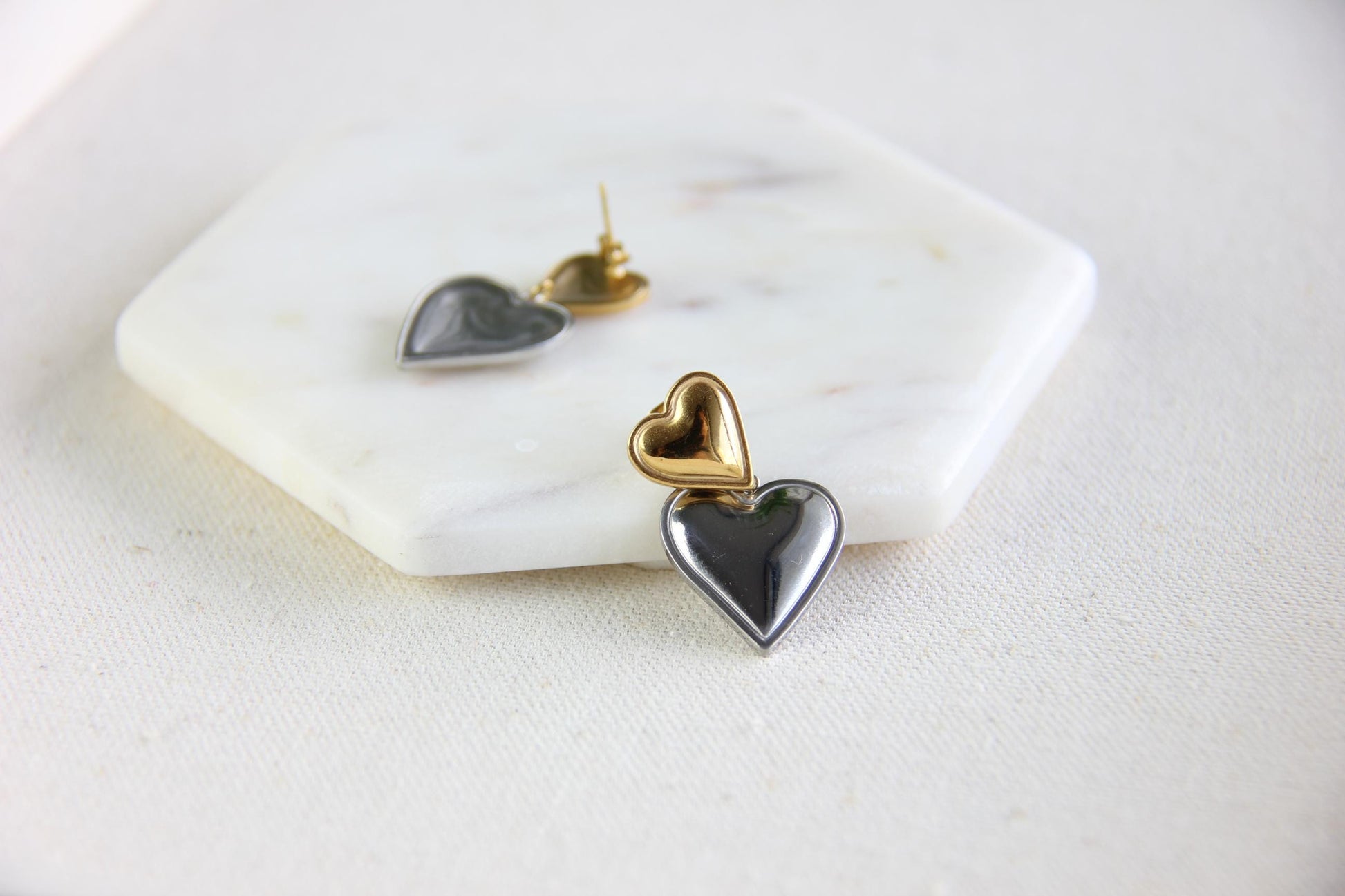 Two-color heart dangle drop earrings in gold and silver, featuring a stylish and modern design. Lightweight and elegant drop earrings, perfect for everyday wear or special occasions. Trendy perfect gift for women and girls who love unique jewelry.