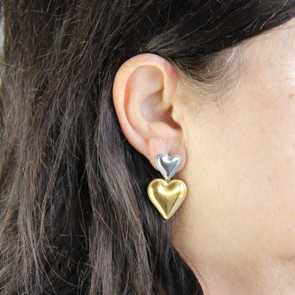 Two-color heart dangle drop earrings in gold and silver, featuring a stylish and modern design. Lightweight and elegant drop earrings, perfect for everyday wear or special occasions. Trendy perfect gift for women and girls who love unique jewelry.
