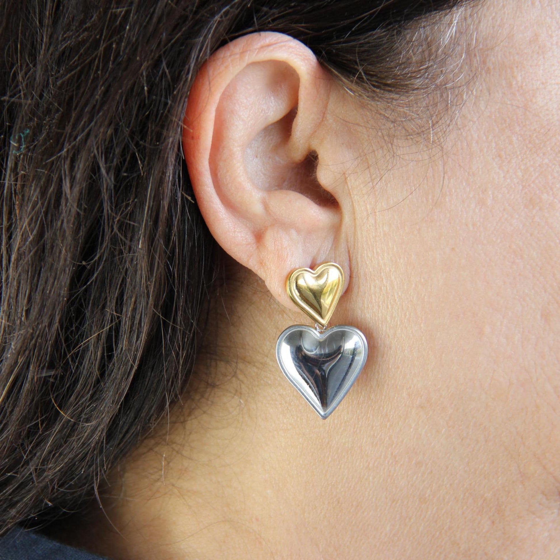 Two-color heart dangle drop earrings in gold and silver, featuring a stylish and modern design. Lightweight and elegant drop earrings, perfect for everyday wear or special occasions. Trendy perfect gift for women and girls who love unique jewelry.