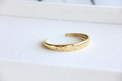 Gold and silver celestial cuff bracelet with star and moon engravings, adorned with sparkling crystals. A stylish celestial-inspired accessory, perfect for stacking or wearing solo. Great celestial jewelry gift for women