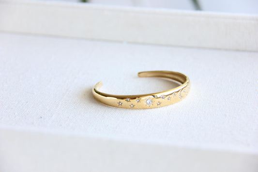 Gold and silver celestial cuff bracelet with star and moon engravings, adorned with sparkling crystals. A stylish celestial-inspired accessory, perfect for stacking or wearing solo. Great celestial jewelry gift for women