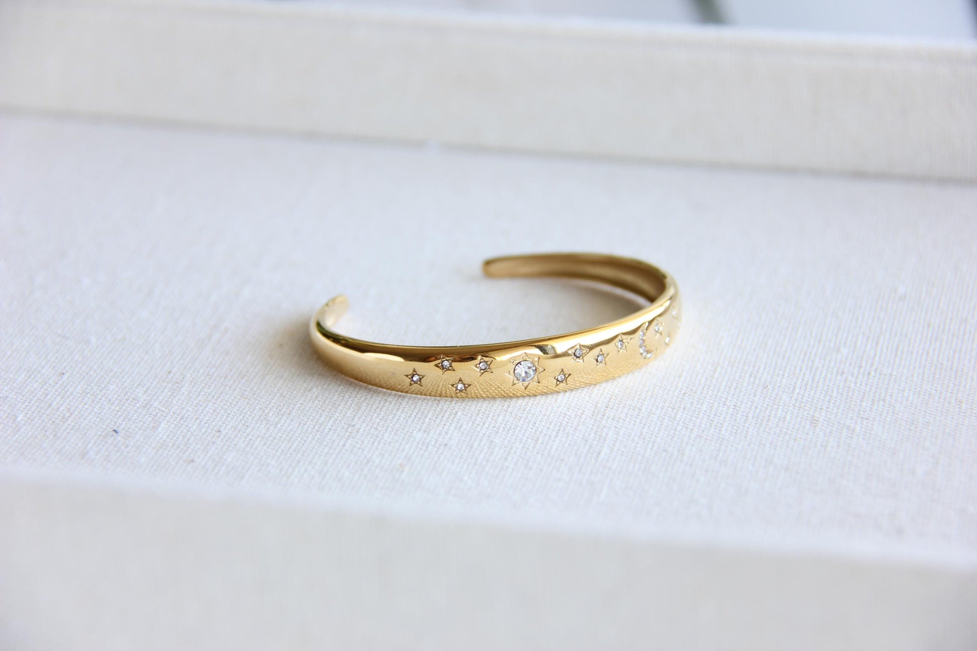 Gold and silver celestial cuff bracelet with star and moon engravings, adorned with sparkling crystals. A stylish celestial-inspired accessory, perfect for stacking or wearing solo. Great celestial jewelry gift for women