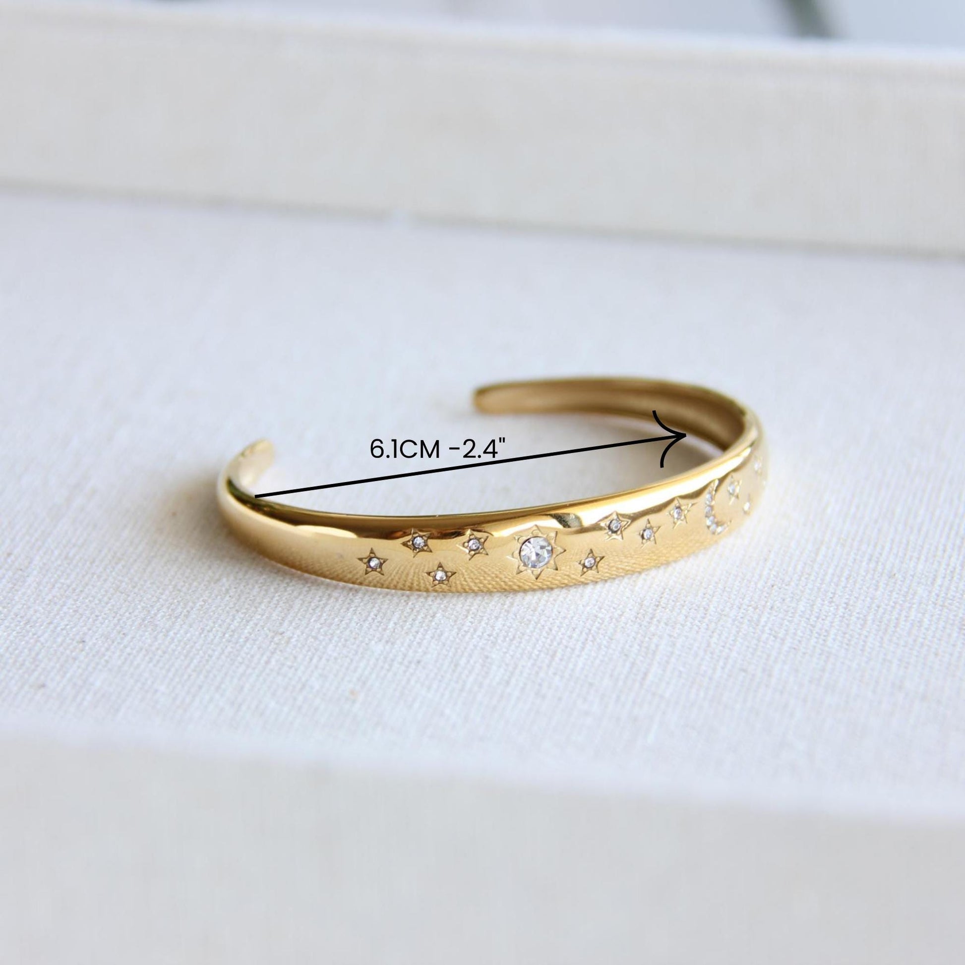 Gold and silver celestial cuff bracelet with star and moon engravings, adorned with sparkling crystals. A stylish celestial-inspired accessory, perfect for stacking or wearing solo. Great celestial jewelry gift for women