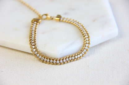 Beautiful zirconia woven gold bracelet with a touch of sparkle. Its delicate design and shimmering stones make it perfect for any outfit. Great for everyday wear, special occasions, or as a lovely gift for her.