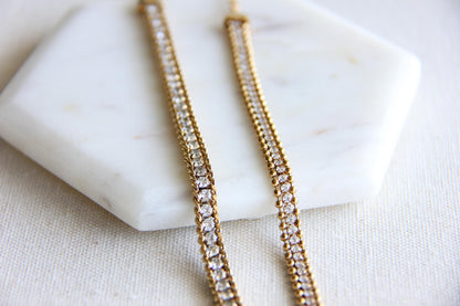 Beautiful zirconia woven gold bracelet with a touch of sparkle. Its delicate design and shimmering stones make it perfect for any outfit. Great for everyday wear, special occasions, or as a lovely gift for her.