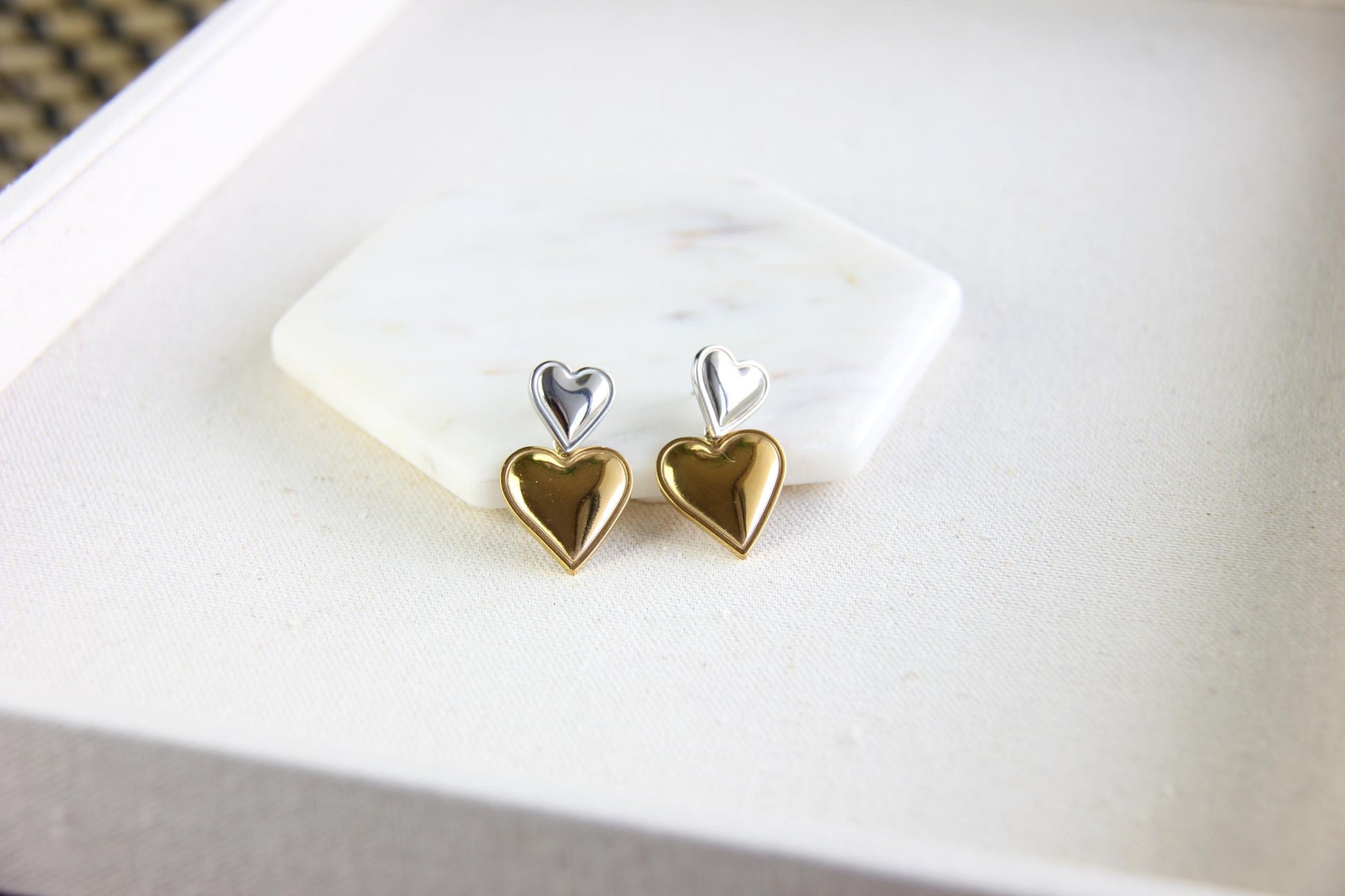 Two-color heart dangle drop earrings in gold and silver, featuring a stylish and modern design. Lightweight and elegant drop earrings, perfect for everyday wear or special occasions. Trendy perfect gift for women and girls who love unique jewelry.