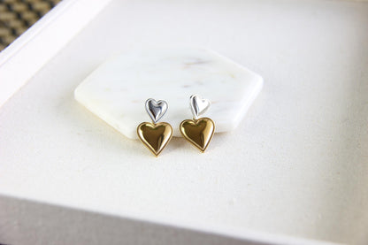 Two-color heart dangle drop earrings in gold and silver, featuring a stylish and modern design. Lightweight and elegant drop earrings, perfect for everyday wear or special occasions. Trendy perfect gift for women and girls who love unique jewelry.
