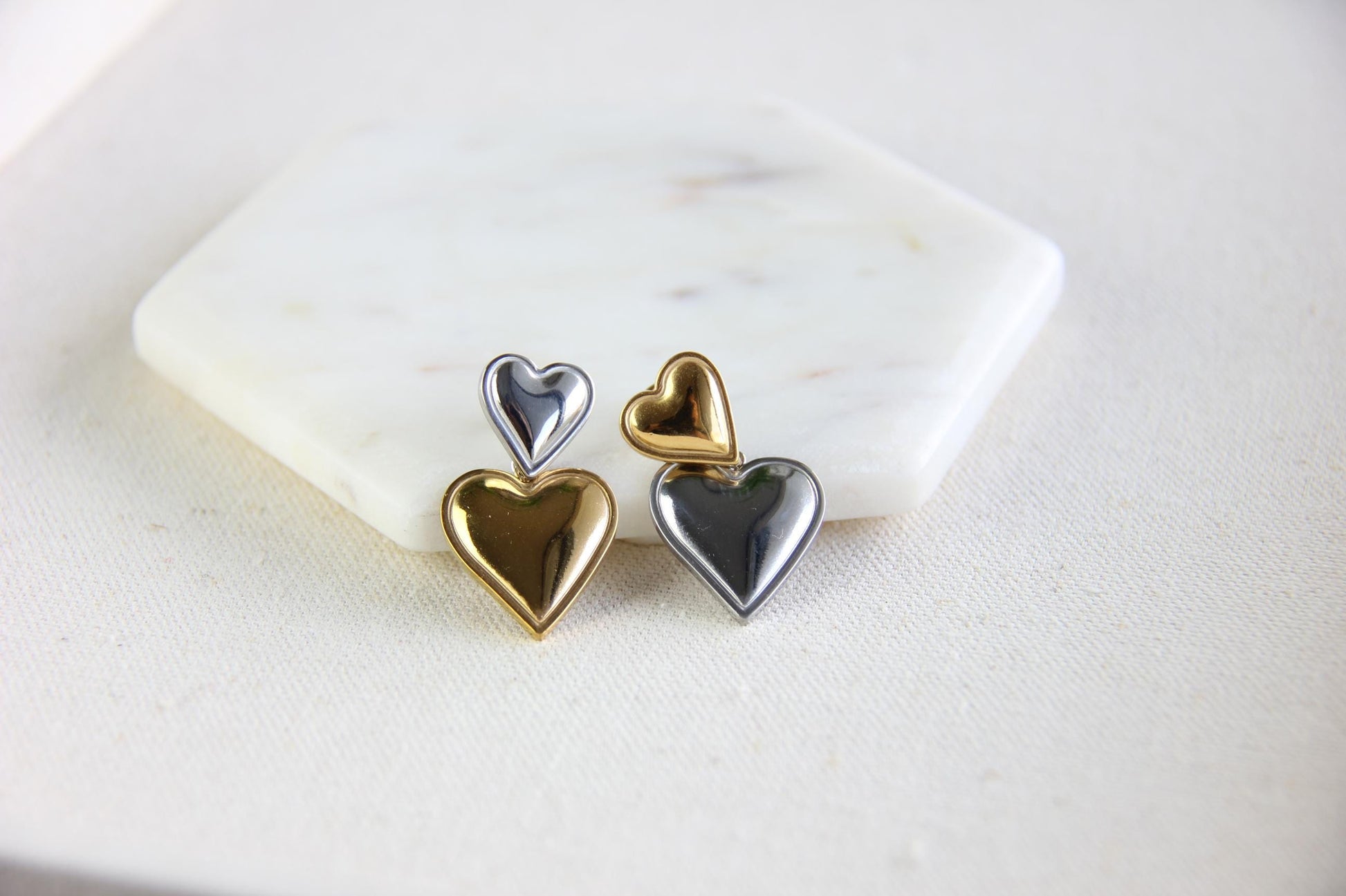 Two-color heart dangle drop earrings in gold and silver, featuring a stylish and modern design. Lightweight and elegant drop earrings, perfect for everyday wear or special occasions. Trendy perfect gift for women and girls who love unique jewelry.