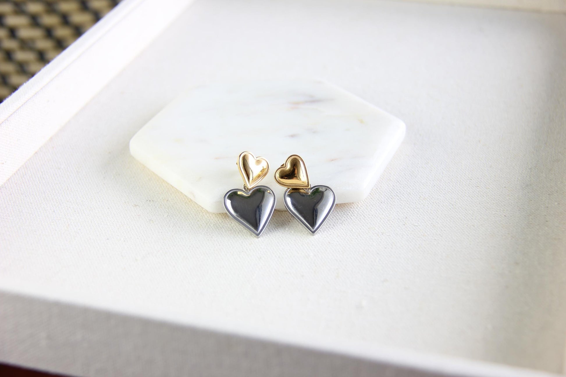 Two-color heart dangle drop earrings in gold and silver, featuring a stylish and modern design. Lightweight and elegant drop earrings, perfect for everyday wear or special occasions. Trendy perfect gift for women and girls who love unique jewelry.