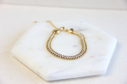 Beautiful zirconia woven gold bracelet with a touch of sparkle. Its delicate design and shimmering stones make it perfect for any outfit. Great for everyday wear, special occasions, or as a lovely gift for her.